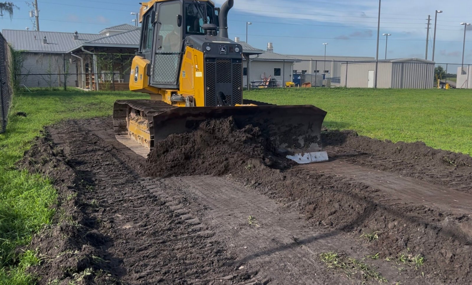 John Deere bulldozer performing precision grading for Orange County Florida police training facility site preparation by Brannigan Land Services