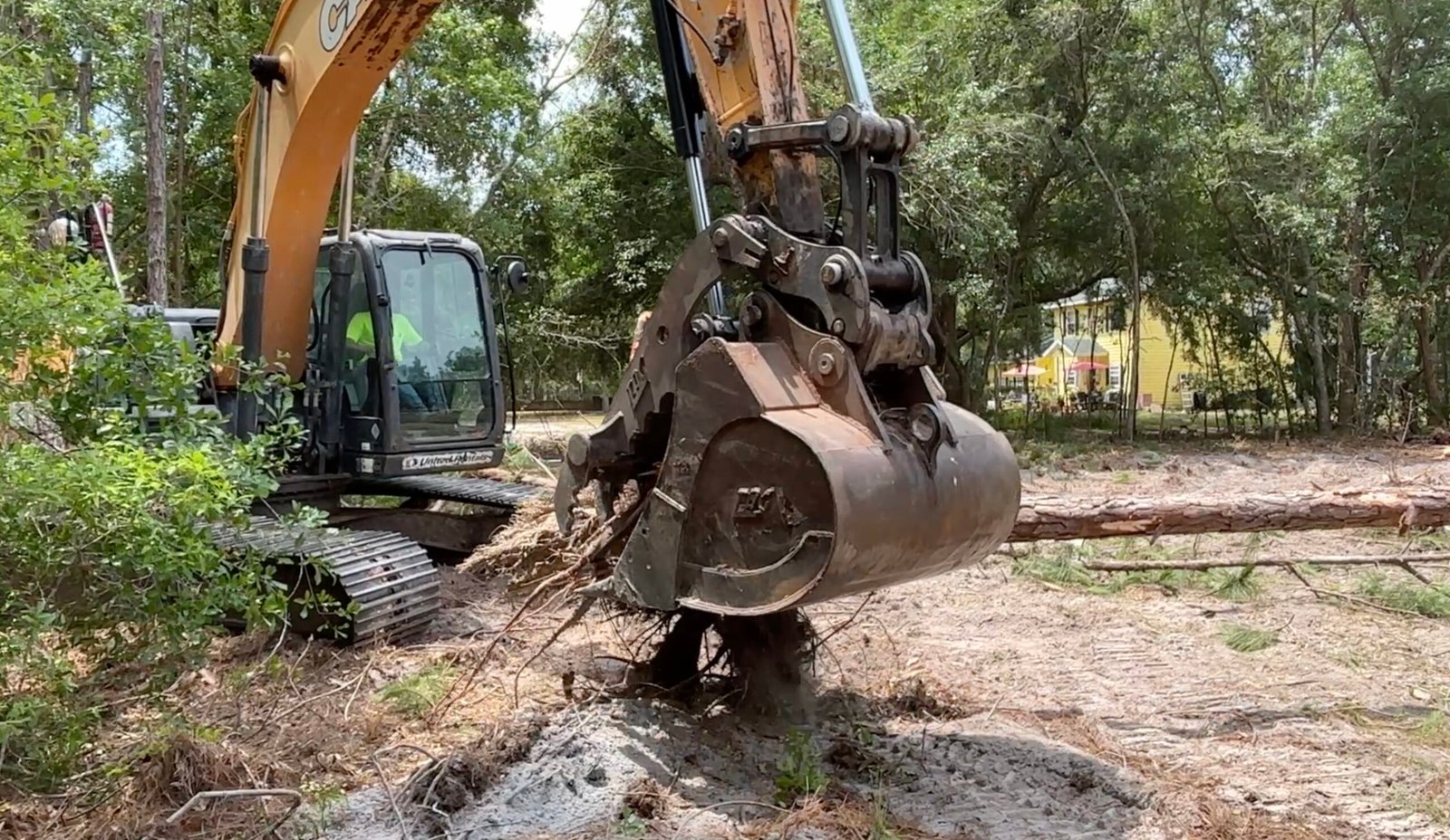 Excavation work near Spring Hill Florida with excavator digging and shaping land for site preparation and drainage improvements