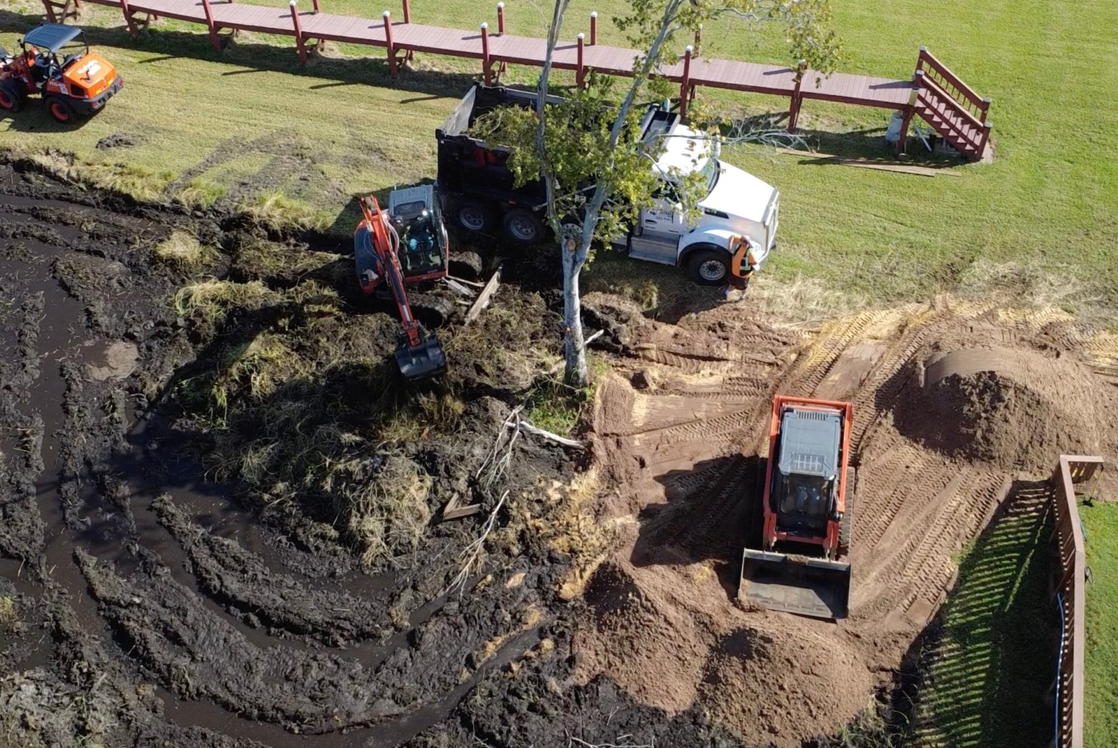 Pond construction in Mount Dora Florida with excavator digging and shaping retention pond in Lake County for site development