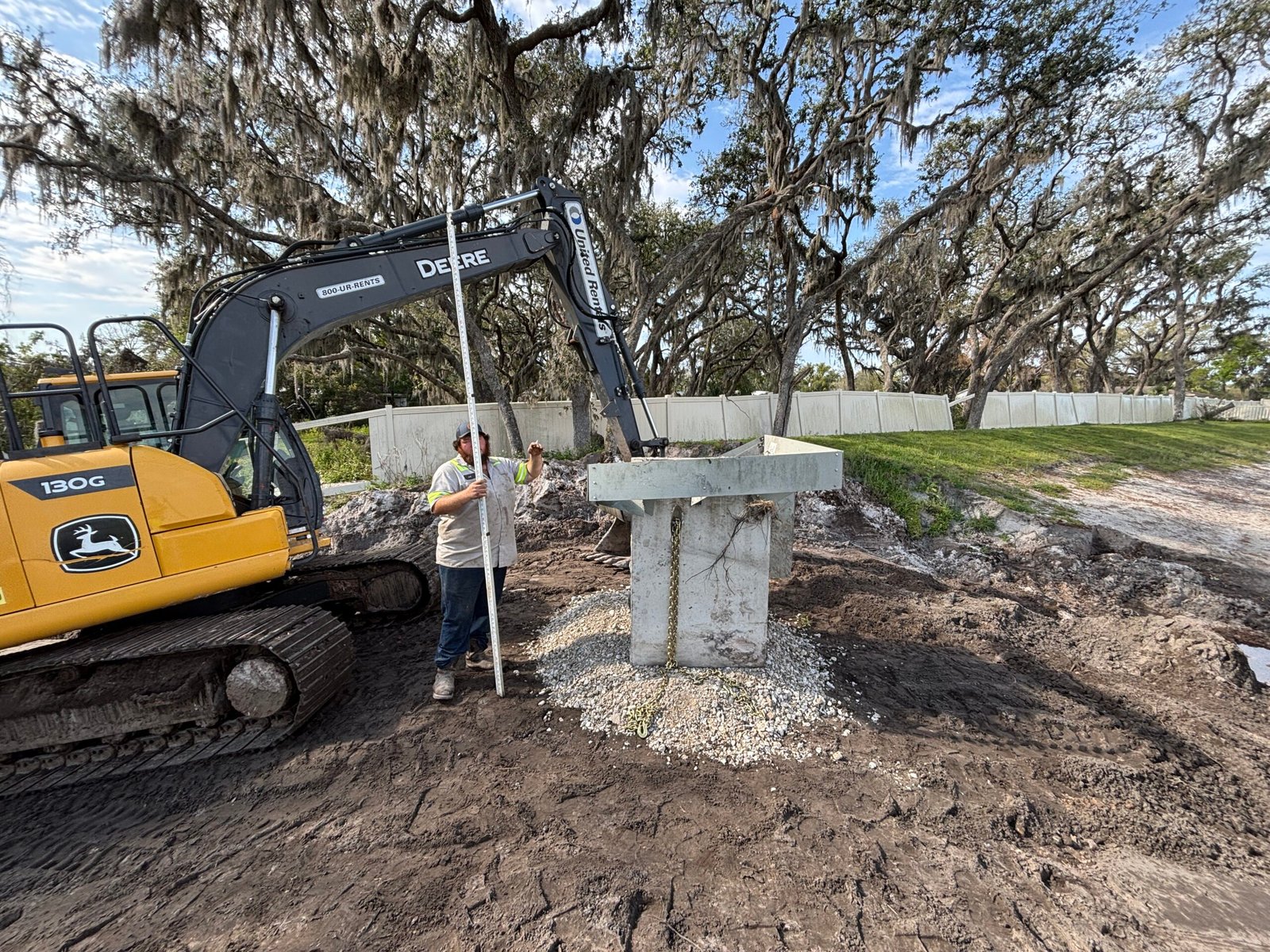 Excavation and site prep for restoring retention pond in Central Florida creating level foundation area for construction