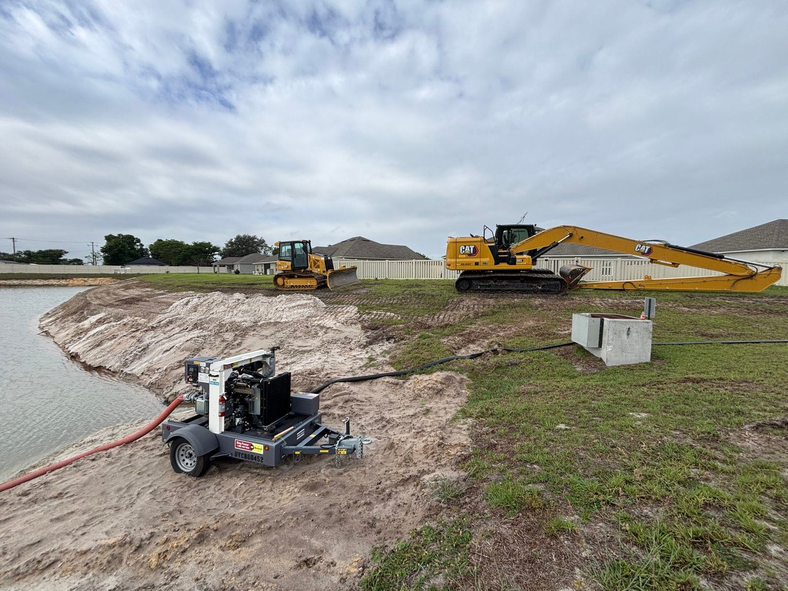 Retention pond restoration in Polk County Florida by Brannigan Land Services with excavator reshaping slopes and improving drainage